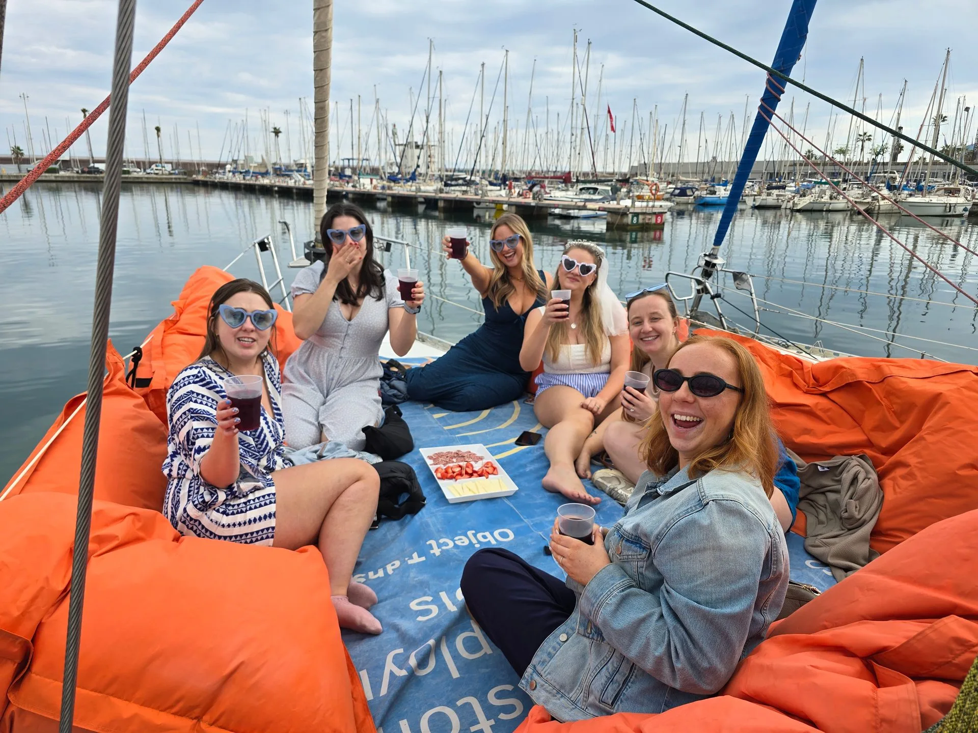 Bachelorette party on sailboat Barcelona - group laughing at the Olympic Port